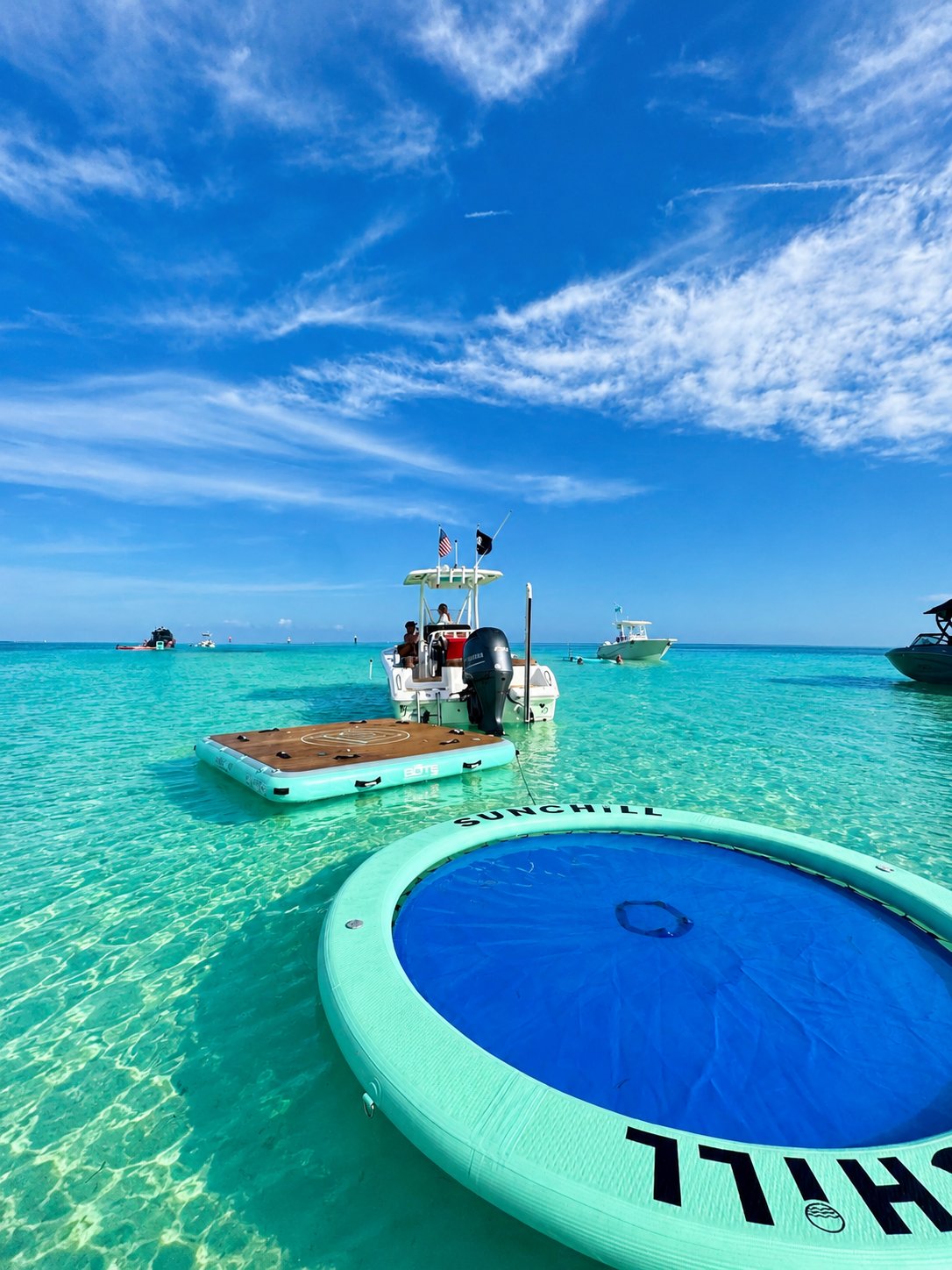 Boats and floating platforms in turquoise Bahamas waters
