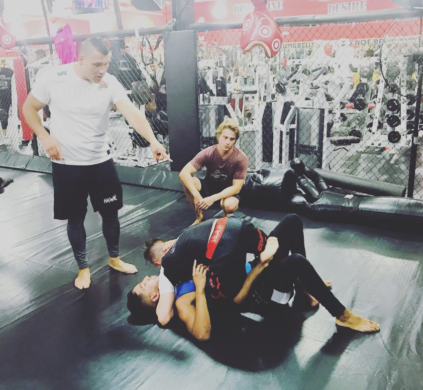 MMA training session inside a cage