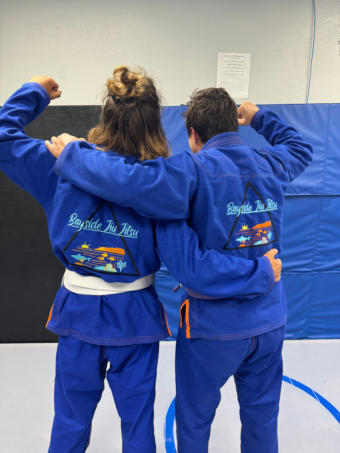 Bayside Jiu Jitsu team members showing off gi patches